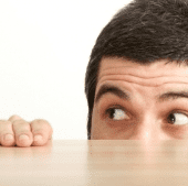 Man looking scared over table top